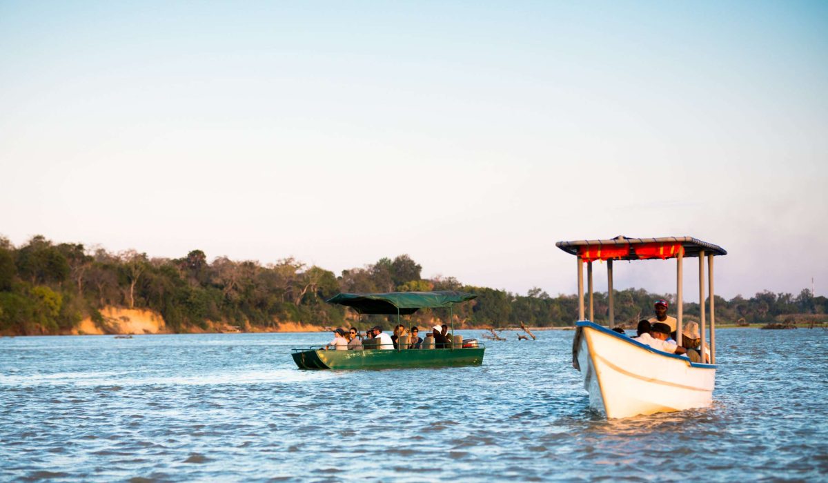 Selous Game Reserve, Tanzania - September 10, 2015: Water safari. Two groups of tourists with local guides are driving with the boat on Rufiji river in Selous Game Reserve (Tanzania, Africa), watching crocodiles and hippos in the river.